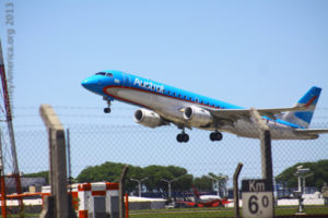 A plane over a busy airport.  The story is obvious.