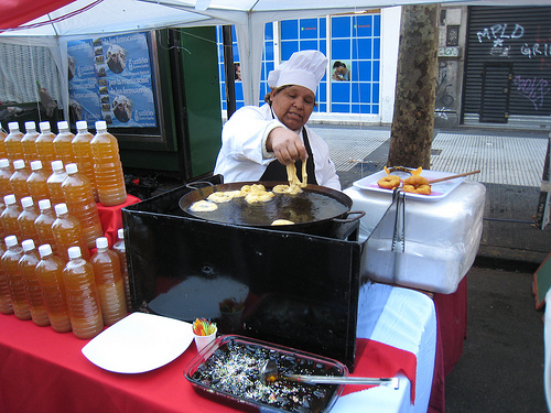 Making picarones, a deep fried squash based dough served with fruits syrup, at the Peruvian festival in Buenos Aires, July 2012
