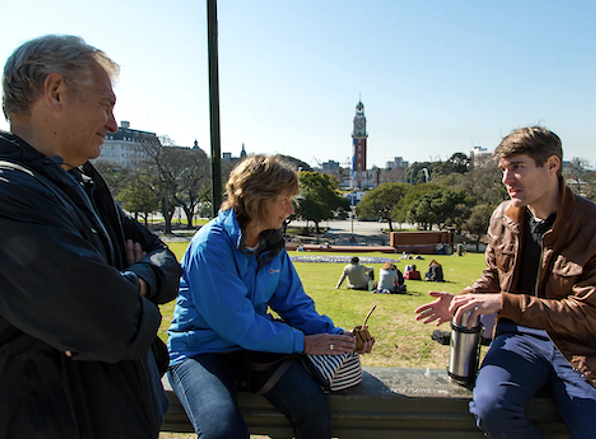 A BuenosTours guide sharing mate with tour guests overlooking Plaza San Martin in Buenos Aires