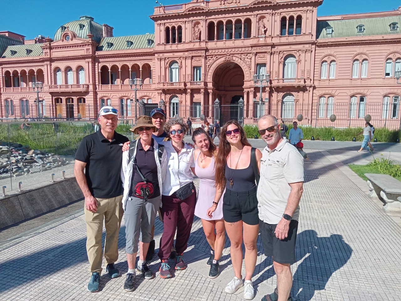 A group standing in Plaza de Mayo in front of the Casa Rosada